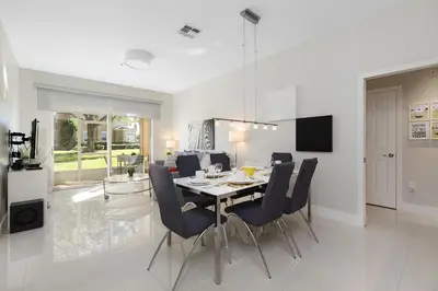 a dining room and kitchen with a table and chairs at One in a Minion #102 in Orlando