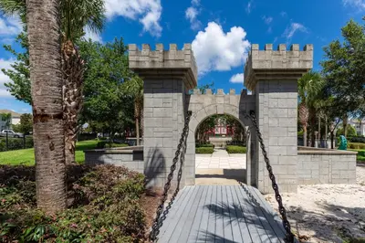 a bridge in a park with a palm tree at Mickey Mouse #104 in Orlando