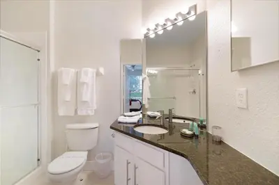 a white bathroom with a toilet and a sink at Windsor Hills Resort #102 in Orlando