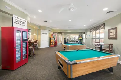 a billiard room with a pool table and a machine at Windsor Hills Resort #102 in Orlando