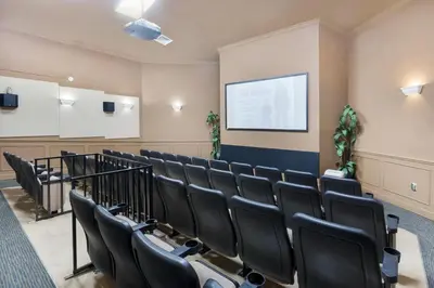 a lecture room with black chairs and a screen at Windsor Hills Resort #102 in Orlando