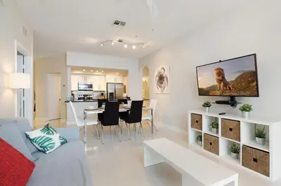 a living room with a couch and a dining room at Windsor Hills Resort #102 in Orlando