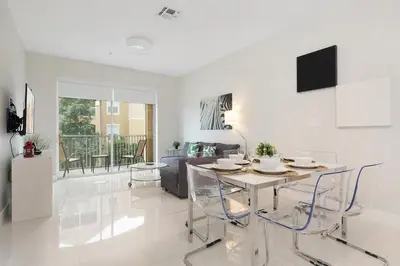 a white living room with a table and chairs at Windsor Hills Resort #202 in Orlando