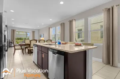 a kitchen with an island with a counter top at 7594 Oasis 8BD Villa- poolspa in Orlando