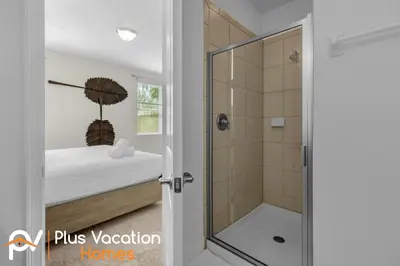 a bathroom with a shower with a glass door at 7594 Oasis 8BD Villa- poolspa in Orlando