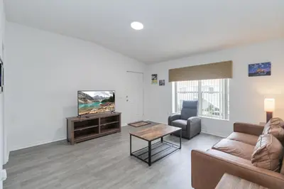a living room with a couch and a tv at Huge Screened Patio That Overlooks Lake Buck, Near Famous Attractions!! in Orlando