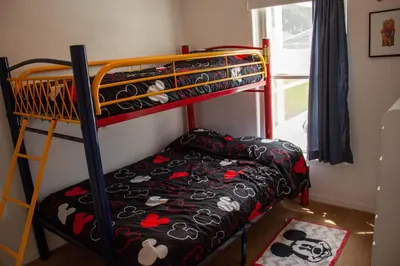 a bedroom with a bunk bed with shoes on it at Florida Escape in Orlando