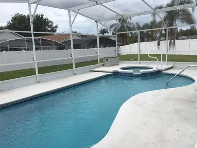 a swimming pool with blue water in a building at Florida Escape in Orlando