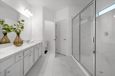 a white bathroom with a glass shower and a sink at 5BR Family Home with Pool & Hot Tub Near Disney in Kissimmee