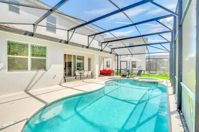 an indoor swimming pool in a house with a glass ceiling at 5BR Family Home with Pool & Hot Tub Near Disney in Kissimmee