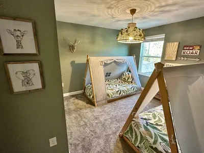 a room with a crib with a mirror in it at Amazing 6br w pvt pool game room near Disney in Kissimmee
