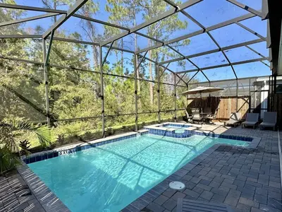 an indoor swimming pool with a glass roof at Amazing 6br w pvt pool game room near Disney in Kissimmee