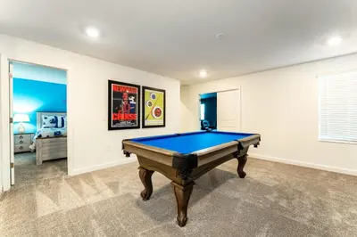 a room with a pool table in it at Amazing 8br villa w theme rms game room theater in Kissimmee