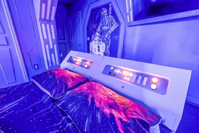 a bed with two umbrellas in a room at Awesome new 8br w theme rooms theater by Disney in Kissimmee