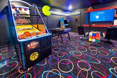 a video game room with a pinball machine at Awesome new 8br w theme rooms theater by Disney in Kissimmee