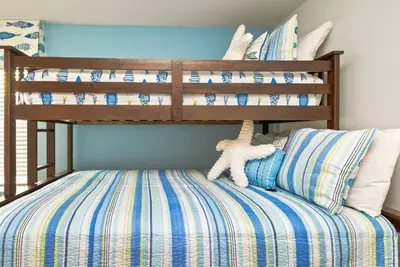 a bedroom with a bunk bed with a stuffed animal at Awesome new 8br w theme rooms theater by Disney in Kissimmee