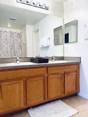 a bathroom with a sink and a large mirror at Lakeside Community, Pools, And More! in Kissimmee