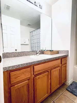 a bathroom with a sink and a mirror at Lakeside Community, Pools, And More! in Kissimmee