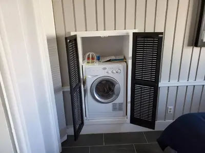 a washer and dryer in a corner of a room at Beautiful cottage near Lake Louisa & mins from Disney, Vehicle Rental Available in Clermont