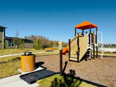 a playground with a slide in a park at 5BR Villa with Game Room and Spa, 12 Min to Disney in Kissimmee