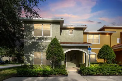 a house with an archway in front of it at Amazing 5BD and 4BH 6 miles from Disney in Kissimmee