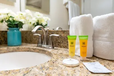 a bathroom counter with two cups on a sink at Amazing 5BD and 4BH 6 miles from Disney in Kissimmee