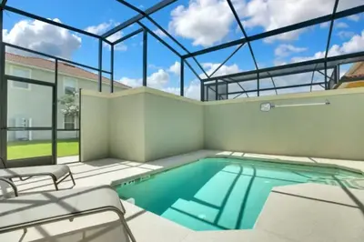 a swimming pool in a house with a glass ceiling at Amazing 5BD and 4BH 6 miles from Disney in Kissimmee