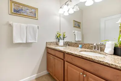 a bathroom with a sink and a mirror at Amazing 5 Bedrooms4 BathsPool at Storey Lake Resort in Kissimmee