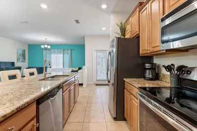 a kitchen with a sink and a refrigerator at Amazing 5 Bedrooms4 BathsPool at Storey Lake Resort in Kissimmee