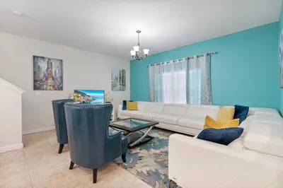 a living room with a couch and a table at Amazing 5 Bedrooms4 BathsPool at Storey Lake Resort in Kissimmee