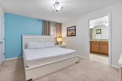 a bedroom with a bed and a mirror at Amazing 5 Bedrooms4 BathsPool at Storey Lake Resort in Kissimmee