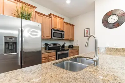 a kitchen with a stainless steel refrigerator and a sink at Amazing 5 Bedrooms4 BathsPool at Storey Lake Resort in Kissimmee