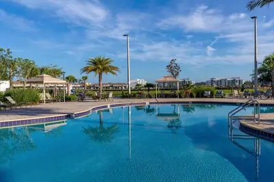 a swimming pool at a resort with blue water at Amazing 5 Bedrooms4 BathsPool at Storey Lake Resort in Kissimmee