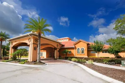 a large orange house with a palm tree at Large Pool Deck * All Rooms w/ Private Bathroom in Kissimmee