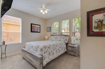 a bedroom with a bed and a ceiling fan at Large Pool Deck * All Rooms w/ Private Bathroom in Kissimmee