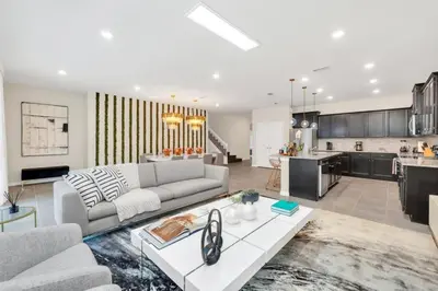 a living room with a couch and a kitchen at Many Themes For Everyone 10 Huge Bedrooms! villa in Kissimmee
