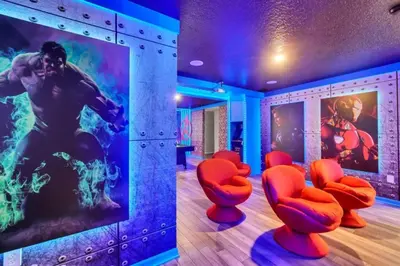a room with red chairs and a painting on the wall at Many Themes For Everyone 10 Huge Bedrooms! villa in Kissimmee