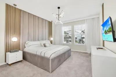 a bedroom with a large bed and a tv at Many Themes For Everyone 10 Huge Bedrooms! villa in Kissimmee