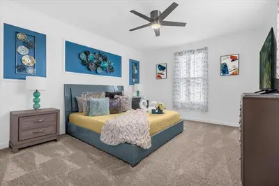 a bedroom with a bed and a ceiling fan at Stylish Resort Villa w Pool Near Disney Gated 5BR in Kissimmee