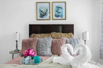 a bedroom with a bed with two white swans at Stylish Resort Villa w Pool Near Disney Gated 5BR in Kissimmee