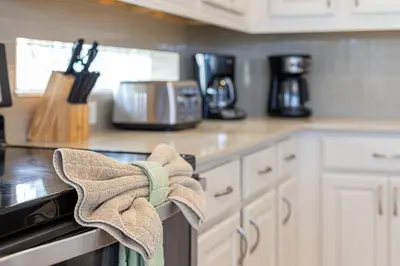 a kitchen with a towel hanging on the stove at #371-Stunning 6 bed with modern decor, south facing pool and spa overlooking water in Kissimmee