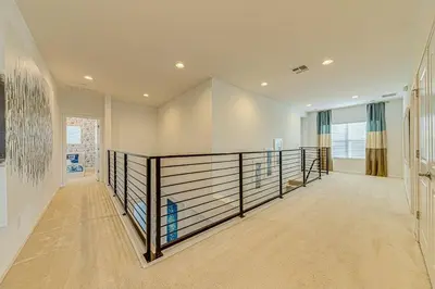 a large hallway with a railing in a house at #371-Stunning 6 bed with modern decor, south facing pool and spa overlooking water in Kissimmee