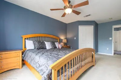 a bedroom with a bed and a ceiling fan at 2739SKP New Emerald Island 4 Bedroom townhouse in Kissimmee