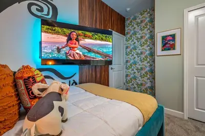 a bedroom with a tv hanging on a wall at Brand New Corner Lot Pond View Vacation Home in Kissimmee