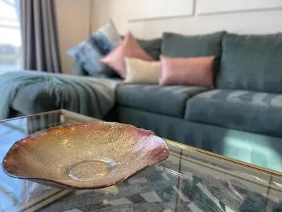 a glass table with a large rock on top of it at #372-Welcome to Lightwater Villa, your Modern Disney Vacation home! South-Facing Pool & Spa Overlooking Lake in Kissimmee