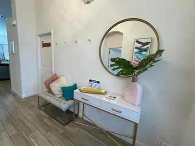 a dressing table with a mirror and a chair at #372-Welcome to Lightwater Villa, your Modern Disney Vacation home! South-Facing Pool & Spa Overlooking Lake in Kissimmee