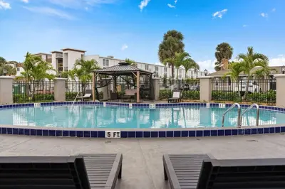 a swimming pool with a gazebo in a resort at Travelodge by Wyndham Kissimmee Orlando in Kissimmee