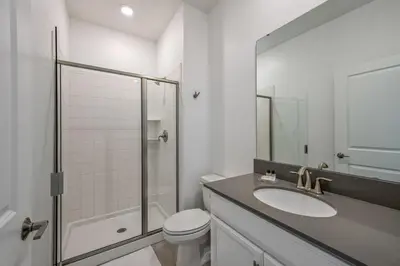 a bathroom with a toilet and a sink and a shower at Brand new home themed bedrooms prime location in Kissimmee