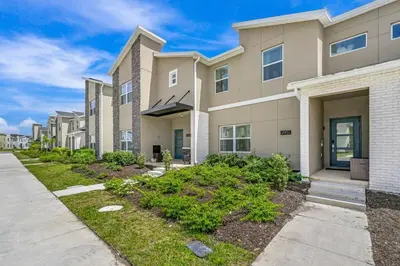 a row of apartment buildings with a sidewalk at Brand new home themed bedrooms prime location in Kissimmee