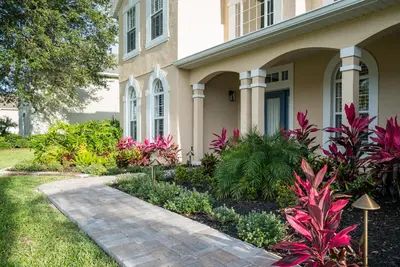 a house with a garden in front of it at Luxury Villa! Fun in the Sun! Formosa Gardens in Orlando